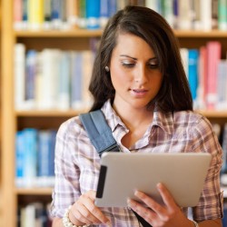 woman-in-library-with-tablet